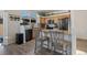 Modern kitchen with light wood cabinets, granite countertops, and island seating at 16935 Buffalo Valley Path, Monument, CO 80132