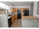 Bright kitchen featuring granite countertops, ample wood cabinetry, and sleek black appliances at 16935 Buffalo Valley Path, Monument, CO 80132