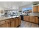 Modern kitchen with light wood cabinets, granite countertops, and stainless steel appliances at 16935 Buffalo Valley Path, Monument, CO 80132