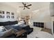 Open living room with sectional sofa, fireplace and view to kitchen at 16935 Buffalo Valley Path, Monument, CO 80132