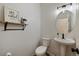 Clean powder room with pedestal sink, toilet and decorative mirror at 16935 Buffalo Valley Path, Monument, CO 80132