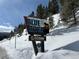 Scenic Blue River welcome sign at 10,000' elevation covered in fresh snow on a sunny day at 98 Leap Year Trl, Breckenridge, CO 80424