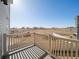 Back deck with white wood railings with a field beyond at 22033 E 38Th Pl, Aurora, CO 80019