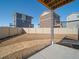 View of the backyard featuring fencing and surrounding two-story homes at 22033 E 38Th Pl, Aurora, CO 80019