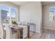 Bright dining area with a modern table, comfortable seating, and scenic outdoor views at 22033 E 38Th Pl, Aurora, CO 80019