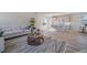 Open-concept living room featuring a modern kitchen with stainless steel appliances and an island with bar seating at 22033 E 38Th Pl, Aurora, CO 80019