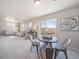 Open floor plan with dining area, leading to a bright living room and sliding glass doors at 22033 E 38Th Pl, Aurora, CO 80019