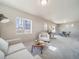 Spacious living room with stylish decor, comfortable seating, and ample natural light at 22033 E 38Th Pl, Aurora, CO 80019
