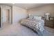 Spacious bedroom with soft carpet, neutral walls, and an ensuite bathroom at 22033 E 38Th Pl, Aurora, CO 80019