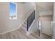 Bright entryway with a contemporary staircase, large window, and light, airy design at 22033 E 38Th Pl, Aurora, CO 80019