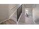 Modern staircase featuring contemporary railings and light-colored carpet and flooring at 22033 E 38Th Pl, Aurora, CO 80019