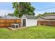 Spacious backyard with a storage shed, patio set and lush green lawn at 2212 Ingalls St, Edgewater, CO 80214