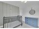 Charming Bedroom with crib and blue dresser creating a calming space for your little one at 2212 Ingalls St, Edgewater, CO 80214