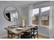 Inviting dining area with wooden table, modern black chairs, and large window offering a charming view at 2212 Ingalls St, Edgewater, CO 80214