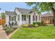 Charming home with a well-manicured front yard, black shutters and chairs, and an American flag at 2212 Ingalls St, Edgewater, CO 80214