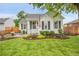 Inviting home with lush front yard and colorful flower beds, showcasing curb appeal at 2212 Ingalls St, Edgewater, CO 80214