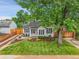 Charming home with a large tree, landscaping, and inviting front yard at 2212 Ingalls St, Edgewater, CO 80214