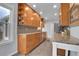 Spacious kitchen with granite countertops, stainless steel appliances, wood cabinets, and tiled backsplash at 2212 Ingalls St, Edgewater, CO 80214