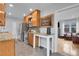 Well-appointed kitchen with stainless steel appliances, wood cabinets, and view into living room at 2212 Ingalls St, Edgewater, CO 80214
