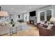 Bright living room boasts hardwood floors, a stone fireplace, and an adjacent dining area with plenty of natural light at 2212 Ingalls St, Edgewater, CO 80214