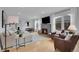 Bright living room featuring hardwood floors, a stone fireplace, and modern decor at 2212 Ingalls St, Edgewater, CO 80214