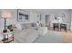 Bright living room with modern furniture and open flow to the dining area at 2212 Ingalls St, Edgewater, CO 80214