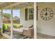 Inviting outdoor patio with comfortable seating, decorative clock, and stylish striped rug at 2212 Ingalls St, Edgewater, CO 80214