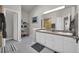 Bright bathroom with dual sinks, modern lighting, neutral color palette, and organized shelving at 5283 Union Ct # 8, Arvada, CO 80002