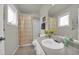 Well-lit bathroom featuring a bathtub with a shower curtain, a vanity, and a neutral color palette at 5283 Union Ct # 8, Arvada, CO 80002