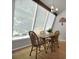 Cozy dining area with a large window and classic wood furniture set perfect for Gathering meals at 5283 Union Ct # 8, Arvada, CO 80002