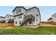 Backyard view with a set of wooden stairs connecting to the patio, green grass and wooden fence at 154 Cortona Pl, Castle Pines, CO 80108