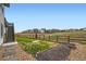 Landscaped backyard with a wooden fence, grass area and a stepping stone pathway at 154 Cortona Pl, Castle Pines, CO 80108
