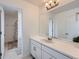 Bright bathroom with a white vanity, neutral flooring, and a shower/bath combo in the next room at 154 Cortona Pl, Castle Pines, CO 80108