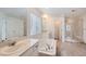 Bright bathroom featuring a soaking tub, double vanity, and a separate glass-enclosed shower at 154 Cortona Pl, Castle Pines, CO 80108
