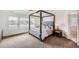 Well-lit bedroom features a four-poster bed, and an en-suite bathroom at 154 Cortona Pl, Castle Pines, CO 80108