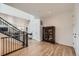 Inviting entryway with hardwood floors, a staircase, and a view of the living and dining areas at 154 Cortona Pl, Castle Pines, CO 80108