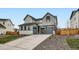 Charming two-story home with a gray exterior, well-maintained landscaping, and a spacious driveway at 154 Cortona Pl, Castle Pines, CO 80108