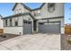 Attractive two-story home with a two-car garage and appealing exterior lighting at 154 Cortona Pl, Castle Pines, CO 80108