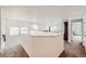 Open hallway with natural light, carpet floors and an open view to the living room at 154 Cortona Pl, Castle Pines, CO 80108
