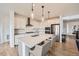 Modern kitchen featuring white cabinetry, stainless steel appliances, a large center island, and pendant lighting at 154 Cortona Pl, Castle Pines, CO 80108