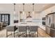 Modern kitchen with a large island, stainless steel appliances, and elegant pendant lighting at 154 Cortona Pl, Castle Pines, CO 80108