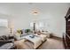Well-lit living room with multiple seating areas, large windows, and carpet at 154 Cortona Pl, Castle Pines, CO 80108