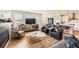 Open-concept living space with modern decor, a fireplace, and seamless flow to the kitchen and dining area at 154 Cortona Pl, Castle Pines, CO 80108
