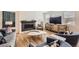 Cozy living room featuring a fireplace, stylish furniture, and ample natural light through the windows at 154 Cortona Pl, Castle Pines, CO 80108