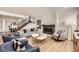 Inviting living room featuring a fireplace, stylish seating, and a staircase at 154 Cortona Pl, Castle Pines, CO 80108