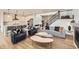 Bright, open-concept living space with modern furnishings, a sleek staircase, and hardwood floors throughout at 154 Cortona Pl, Castle Pines, CO 80108