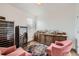 Home lounge with a wall-mounted wine cooler, a counter full of bottles and two lounge chairs at 154 Cortona Pl, Castle Pines, CO 80108
