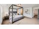 Serene main bedroom with a four-poster bed, neutral color palette, and a tranquil ambiance at 154 Cortona Pl, Castle Pines, CO 80108