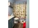 Bathroom with vanity, toilet, and beach-themed shower curtain at 12505 N 3Rd St, Parker, CO 80134