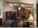 Living room with wood-paneled walls, a fireplace, and a ceiling fan at 12505 N 3Rd St, Parker, CO 80134